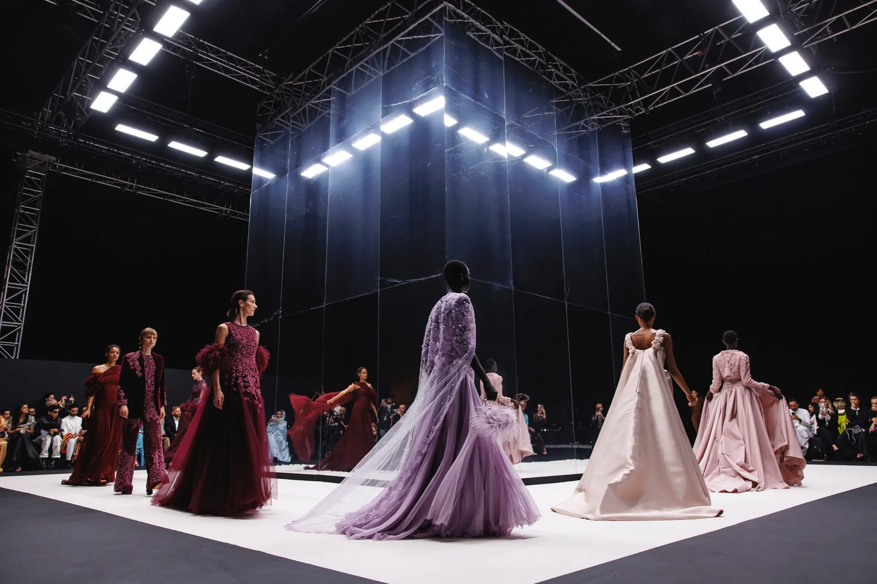 Couture runway show with models in evening gowns